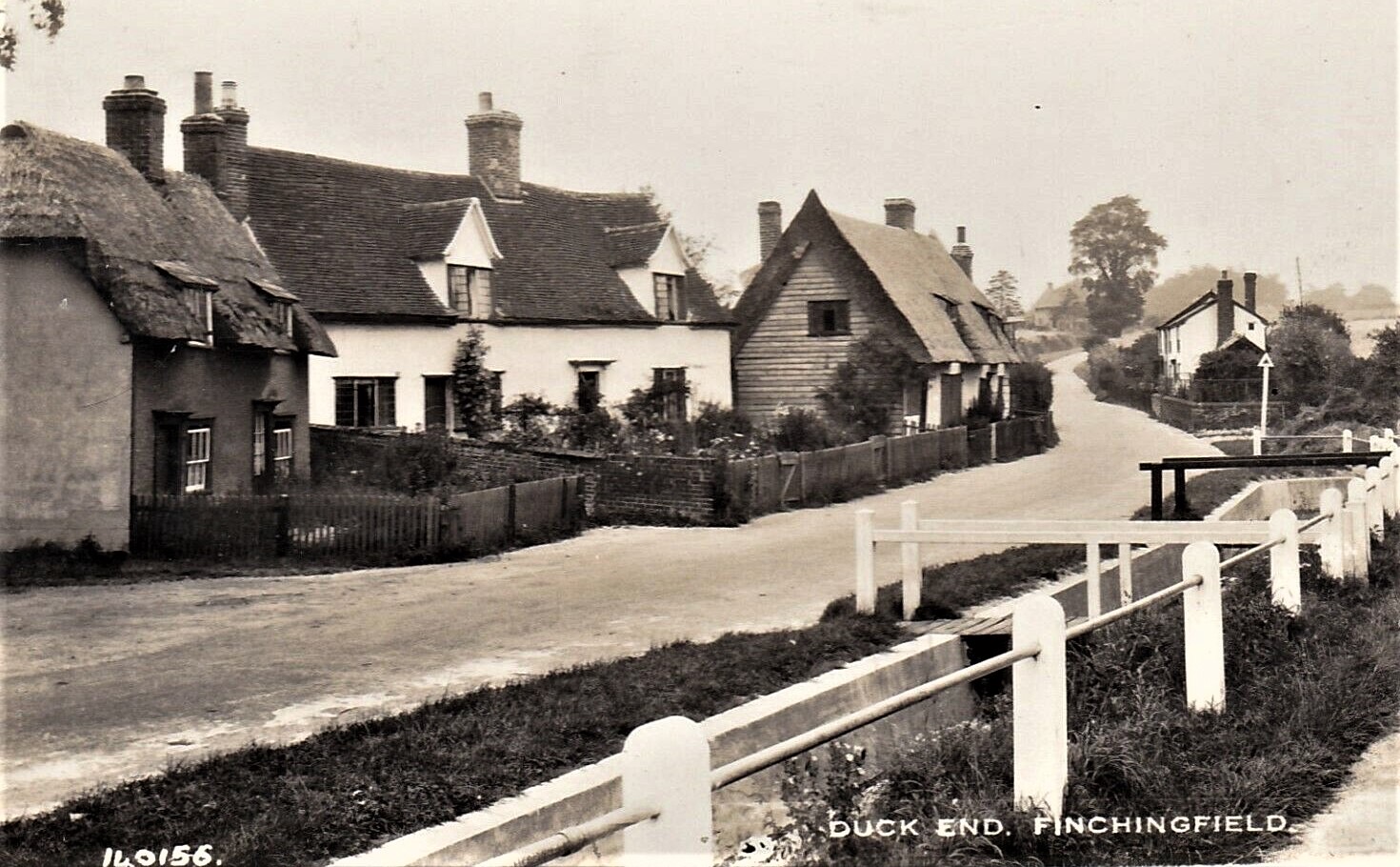 Vintage real-photo postcard of Duck End, Finchingfield, showing thatched cottages and the windmill